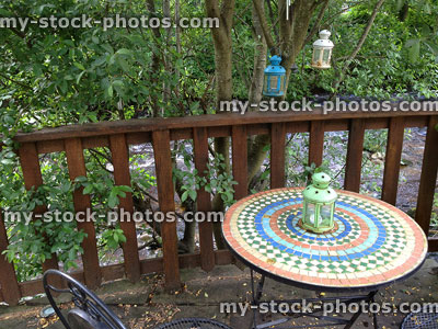 Stock image of metal patio table and chairs with mosaic tabletop