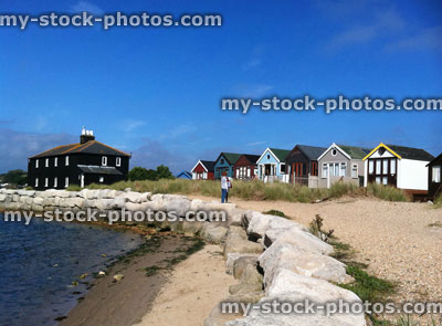 Stock image of children infront of beach huts on Mudeford Spit, Dorset, England