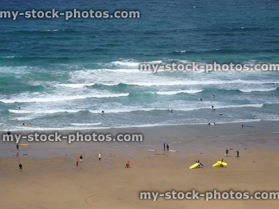 Stock image of a surfing school lesson on sandy Cornish coastline