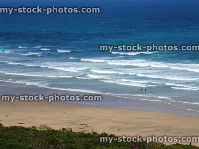Stock image of kitesurfer riding waves off the coastline, Newquay, Cornwall