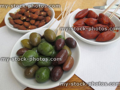 Stock image of appetisers / small starters at restaurant, mixed olives, chorizo sausages, almonds