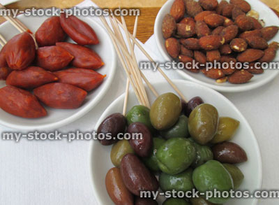 Stock image of appetisers / small starters at restaurant, mixed olives, chorizo sausages, almonds