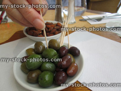 Stock image of appetisers / small starters at restaurant, mixed olives and salted almonds