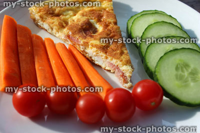 Stock image of Spanish tortilla omelette, healthy lunch, raw salad vegetables