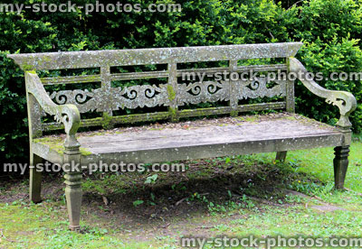 Stock image of ornate old wooden bench / weathered garden seat