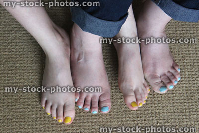 Stock image of feet, toenails painted with nail varnish, blue / yellow