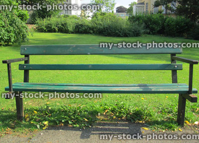 Stock image of metal and wooden garden park bench painted green
