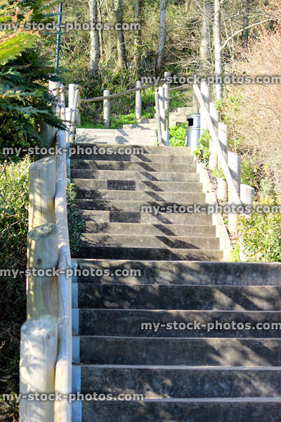 Stock image of concrete stairs leading upwards into distance in park gardens