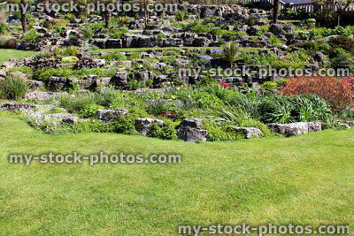Stock image of rock garden (rockery) and manicured lawn grass