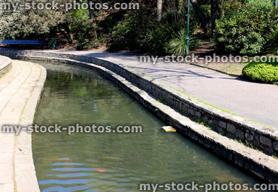 Stock image of wide stream with clear water flowing through gardens