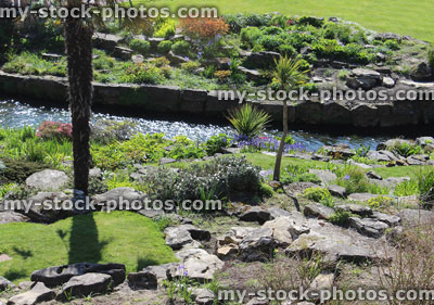 Stock image of established English rock garden (rockery) with stream
