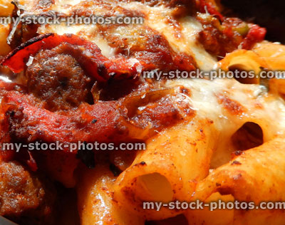 Stock image of penne / rigatoni pasta with meatballs, melted cheese, peppers