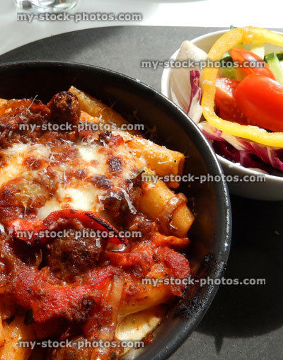 Stock image of penne / rigatoni pasta with meatballs, melted cheese, peppers