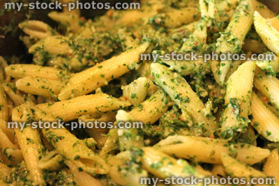 Stock image of freshly made pesto sauce mixed with penne pasta