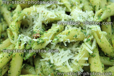 Stock image of homemade pesto pasta topped with grated parmesan cheese