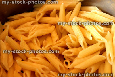 Stock image of freshly cooked penne pasta in saucepan, without sauce