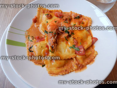 Stock image of seafood ravioli pasta, rich tomato sauce, king prawn