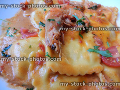Stock image of seafood ravioli pasta, rich tomato sauce, king prawn