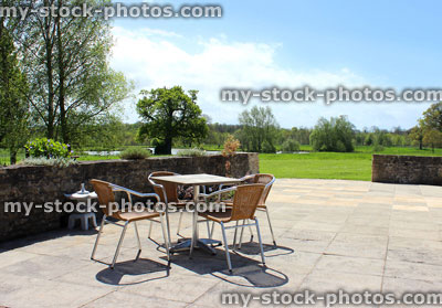 Stock image of modern outside table and chairs in landscaped Japanese Zen garden