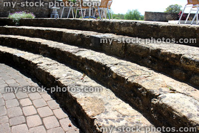 Stock image of paving, curved stone steps and al fresco dining