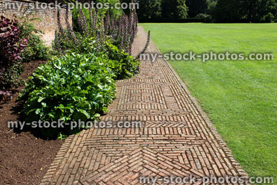 Stock image of red brick path, block paving, paved pathway, basketweave / diamond pattern