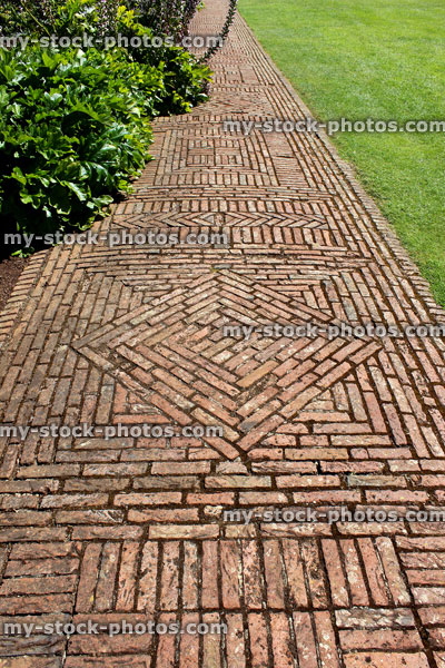 Stock image of red brick path, block paving, paved pathway, basketweave / diamond pattern