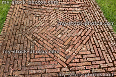 Stock image of red brick path, block paving, paved pathway, diamond pattern / lawn