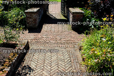 Stock image of red brick path, block paving, paved pathway, 45 degree herringbone pattern