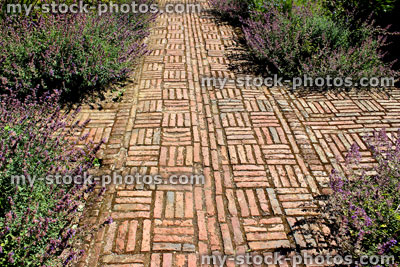 Stock image of red brick path, block paving, paved pathway, basketweave pattern, cross / crossroads