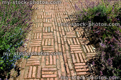Stock image of red brick path, block paving, paved pathway, basketweave pattern