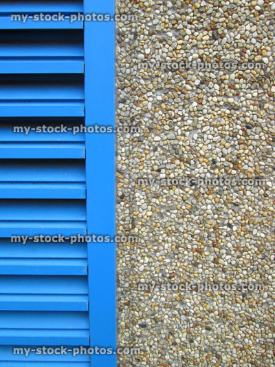 Stock image of roughcast / pebbledash, wall texture background, blue louvre door, plaster cement render