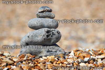 Stock image of balancing tower / stack of grey pebbles on shingle beach