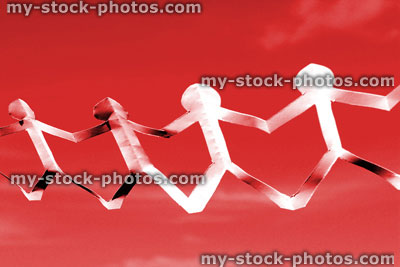 Stock image of white people paper chain of dolls, men holding hands, red background