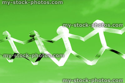 Stock image of white people paper chain of dolls, men holding hands, green background