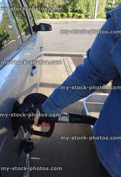 Stock image of car being filled with petrol / diesel / gas, fuel filling station