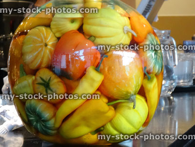 Stock image of jar with yellow / orange pickled gourds, peppers, chilies