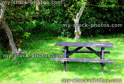 Stock image of traditional wooden picnic table with fixed bench seating