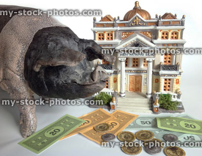 Stock image of piggy bank, model pig with building, toy money