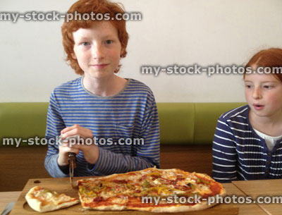 Stock image of boy and girl in a pizza restaurant