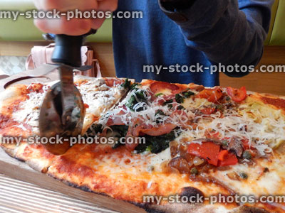 Stock image of rectangular cheese and tomato margherita pizza, Italian restaurant, pizza wheel cutter