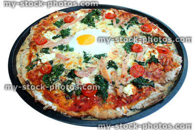Stock image of homemade Florentine pizza with spinach, ham and egg (close up)