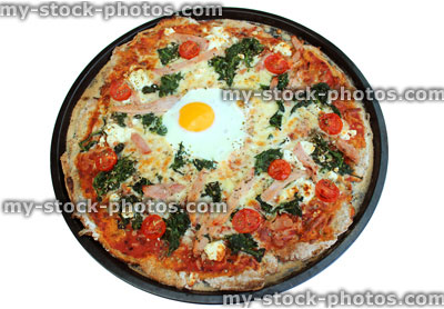 Stock image of homemade Florentine pizza with spinach, ham and egg (close up)