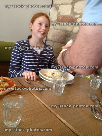 Stock image of girl being served in a pizza restaurant
