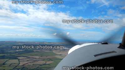Stock image of small two seater private plane flying in sky, flying lesson