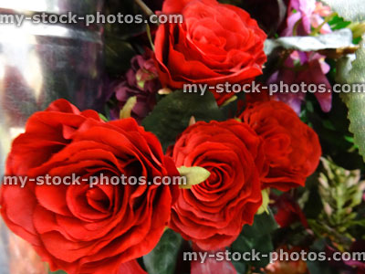 Stock image of artificial plastic / silk rose flowers, fake red roses
