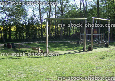Stock image of children's wooden play equipment in garden, monkey bars