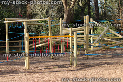 Stock image of woodland children's playground with wooden climbing equipment