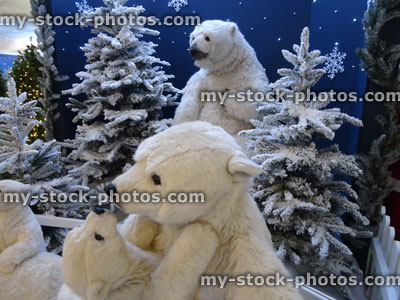 Stock image of large cuddly life size cartoon / fluffy toy polar bears, baby polar bear, winter display