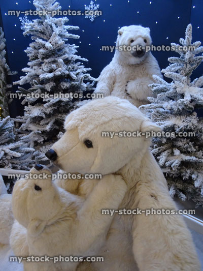 Stock image of large cuddly life size cartoon / fluffy toy polar bears, baby polar bear, winter display