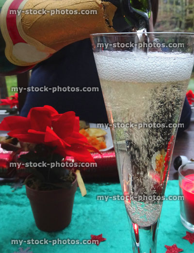 Stock image of champagne / sparkling wine being poured into flute wine-glass